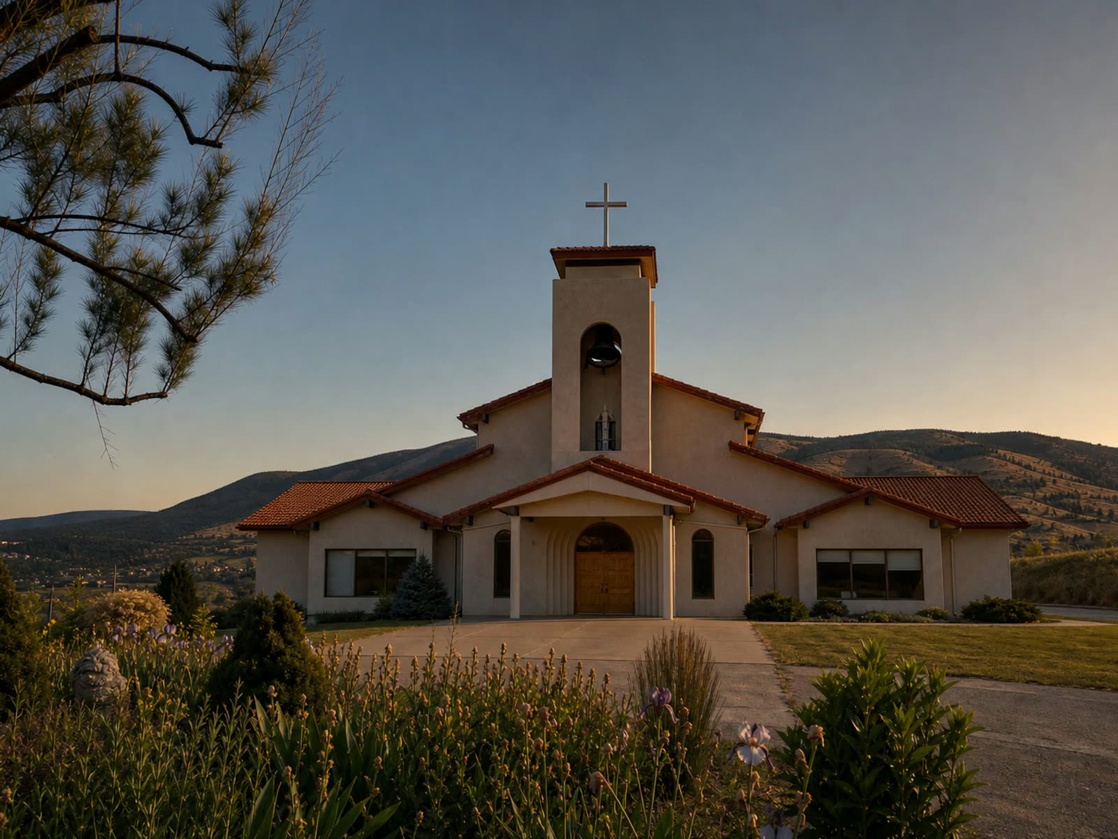 Our Lady of the Valley Church framed by trees.
